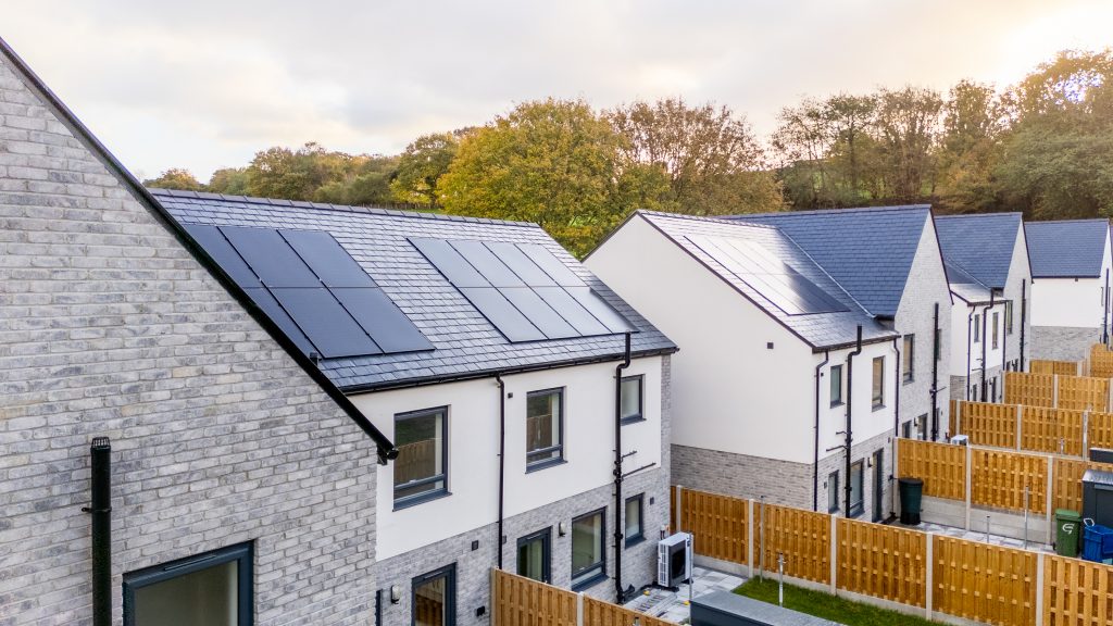 Picture of some of the homes with solar panels and air source heat pumps.