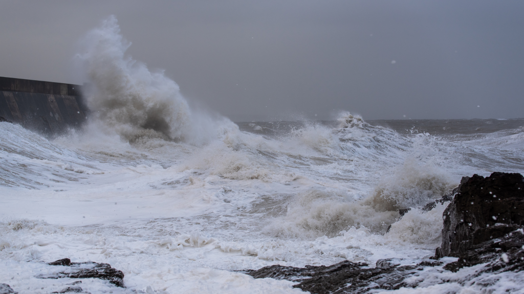 Storm, sea waves hitting the rocks.